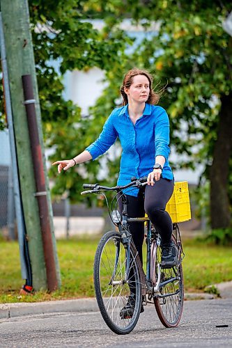 NIC ADAM / FREE PRESS
Hillary Rosentreter, pictured at the corner of Annabella St. and Sutherland Ave. Wednesday, is calling for the province to change the Highway Traffic Act to allow those on bikes to do an &#x201c;Idaho stop,&#x201d; basically treating stop signs as yields where they can proceed through as safe without coming to a full stop. 
240821 - Wednesday, August 21, 2024.

Reporter: Joyanne