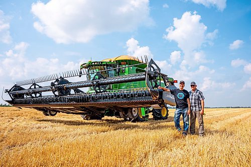 NIC ADAM / FREE PRESS
Foodgrains regional representative Gordon Janzen (left) and Landmark growing project coordinator Randy Plett pictured next to a combine at the growing project&#x2019;s field outside Landmark, MB., Tuesday.
240820 - Tuesday, August 20, 2024.

Reporter: