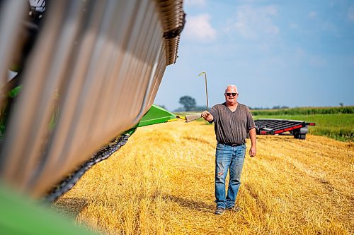 NIC ADAM / FREE PRESS
Farm man Steve Schultz pictured next to his John Deere Combine, just one of the 11 combines and several grain trucks that worked a field outside Landmark, MB., Tuesday, the proceeds of which will be donated to the Foodgrains Bank. 
240820 - Tuesday, August 20, 2024.

Reporter: