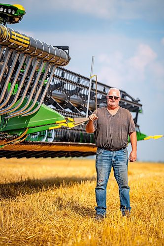 NIC ADAM / FREE PRESS
Farm man Steve Schultz pictured next to his John Deere Combine, just one of the 11 combines and several grain trucks that worked a field outside Landmark, MB., Tuesday, the proceeds of which will be donated to the Foodgrains Bank. 
240820 - Tuesday, August 20, 2024.

Reporter: