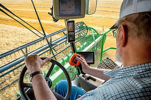 NIC ADAM / FREE PRESS
Farmer Larry Goossen, 80, works in his John Deere combine at the growing project&#x2019;s field outside Landmark, MB., Tuesday. He&#x2019;s been driving a combine since he was 14 and likes to volunteer for the project every year.
240820 - Tuesday, August 20, 2024.

Reporter: