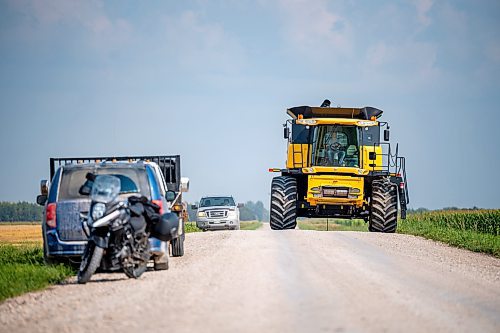 NIC ADAM / FREE PRESS
11 combines and several grain trucks work pulling grain out of the ground at a field outside Landmark, MB., Tuesday, the proceeds of which will be donated to the Foodgrains Bank. 
240820 - Tuesday, August 20, 2024.

Reporter: