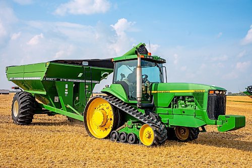 NIC ADAM / FREE PRESS
11 combines and several grain trucks work pulling grain out of the ground at a field outside Landmark, MB., Tuesday, the proceeds of which will be donated to the Foodgrains Bank. 
240820 - Tuesday, August 20, 2024.

Reporter: