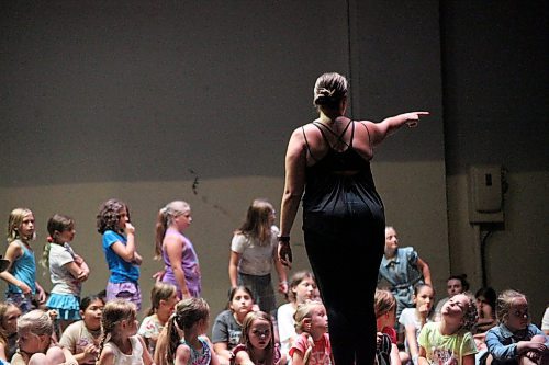 Tiana Vasconcelos directs primary and interim aged children on stage at the Western Manitoba Centennial Auditorium on Thursday. The Mecca summer camp saw its biggest year with more than 160 kids signed up. (Connor McDowell/Brandon Sun)