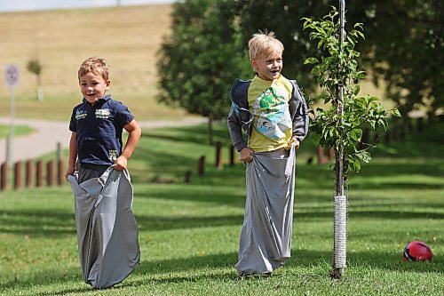 Four-year-old Alex Stefanov and six-year-old Damon Carmichael hop in pillowcases while having fun in a sack race with other kids at Dinsdale Park on Thursday during a get-together by families in the Westman Elementary Homeschoolers group. (Tim Smith/The Brandon Sun)