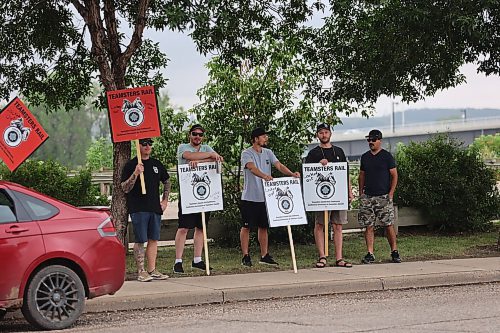 Some Teamsters Rail members picket at the CPKC Brandon office located at 355 Pacific Ave. on Thursday morning. About 15 union members picket at the general yard office with 'Lock out' plaqad. (Abiola Odutola/The Brandon Sun)