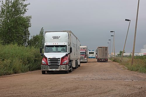 Trucks make their way out of Maple Leaf Foods Brandon located at 6355 Richmond Ave East on Thursday. (Abiola Odutola/The Brandon Sun)