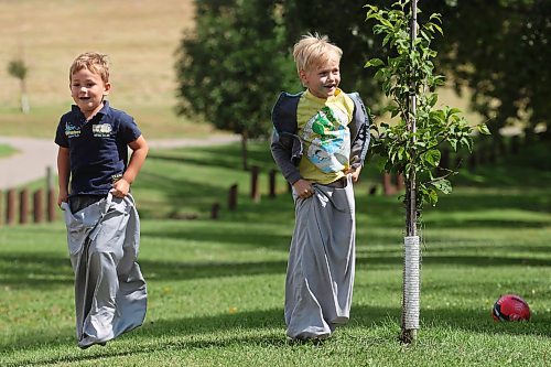 22082024
Four-year-old Alex Stefanov and six-year-old Damon Carmichael hop in pillowcases while having fun in a sack race with other kids at Dinsdale Park on Thursday during a get-together by families in the Westman Elementary Homeschoolers group.
(Tim Smith/The Brandon Sun)