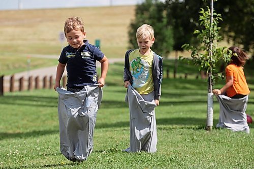 22082024
Four-year-old Alex Stefanov and six-year-old Damon Carmichael hop in pillowcases while having fun in a sack race with other kids at Dinsdale Park on Thursday during a get-together by families in the Westman Elementary Homeschoolers group.
(Tim Smith/The Brandon Sun)