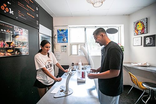 MIKAELA MACKENZIE / WINNIPEG FREE PRESS
	
Naz Kahil takes Josh Mednoza&#x573; order at Danook Restaurant on Friday, Aug. 23, 2024. The Syrian establishment has a tipping prompt, which helps staff; the restaurant can't afford to pay staff higher wages without raising its menu prices, the owner said. 

For Gabby story.
Winnipeg Free Press 2024