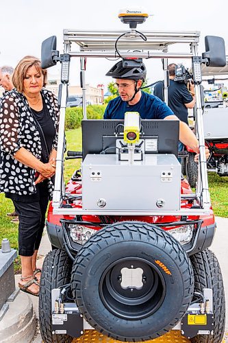 NIC ADAM / FREE PRESS
Field tech Kenneth Morrison (right) shows off the city&#x2019;s new sidewalk surface testing vehicles to Coun. Janice Lukes on the sidewalk in front of 2855 Pembina Hwy. Friday.
240823 - Friday, August 23, 2024.

Reporter: Joyanne