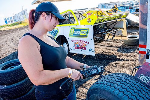 NIC ADAM / FREE PRESS
Hayley Pederson shaves her teams tires at Thursday night thunder at Victory Lanes Speedway. This helps rejuvenate the rubber and gives the driver more grip on the track.
240822 - Thursday, August 22, 2024.

Reporter: ?