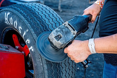 NIC ADAM / FREE PRESS
Hayley Pederson shaves her teams tires at Thursday night thunder at Victory Lanes Speedway. This helps rejuvenate the rubber and gives the driver more grip on the track.
240822 - Thursday, August 22, 2024.

Reporter: ?