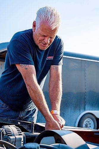 NIC ADAM / FREE PRESS
Dave Rogers works on his car before racing at Thursday night thunder at Victory Lanes Speedway. 
240822 - Thursday, August 22, 2024.

Reporter: ?