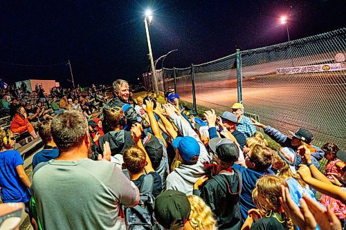 NIC ADAM / FREE PRESS
Midwest modified winner Rick Delaine gives his trophy to a young spectator at Thursday night thunder at Victory Lanes Speedway. 
240822 - Thursday, August 22, 2024.

Reporter: ?