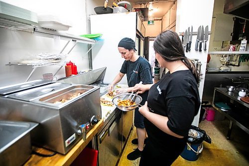 MIKAELA MACKENZIE / WINNIPEG FREE PRESS
	
Riwas Kahil (left) and Marab Hamada make chicken shawarma wraps at Danook Restaurant on Friday, Aug. 23, 2024. The Syrian establishment has a tipping prompt, which helps staff; the restaurant can't afford to pay staff higher wages without raising its menu prices, the owner said. 

For Gabby story.
Winnipeg Free Press 2024