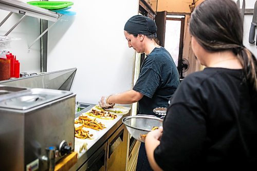 MIKAELA MACKENZIE / WINNIPEG FREE PRESS
	
Riwas Kahil (left) and Marab Hamada make chicken shawarma wraps at Danook Restaurant on Friday, Aug. 23, 2024. The Syrian establishment has a tipping prompt, which helps staff; the restaurant can't afford to pay staff higher wages without raising its menu prices, the owner said. 

For Gabby story.
Winnipeg Free Press 2024