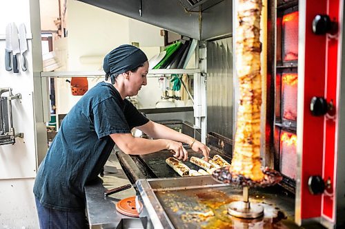 MIKAELA MACKENZIE / WINNIPEG FREE PRESS
	
Riwas Kahil makes chicken shawarma wraps at Danook Restaurant on Friday, Aug. 23, 2024. The Syrian establishment has a tipping prompt, which helps staff; the restaurant can't afford to pay staff higher wages without raising its menu prices, the owner said. 

For Gabby story.
Winnipeg Free Press 2024