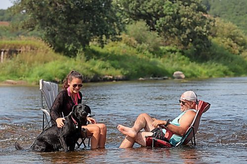 22082024
Victoria and Stephen Findlay cool their heels in the Little Saskatchewan River along with their dog Wesley on a hot Friday afternoon.  (Tim Smith/The Brandon Sun)