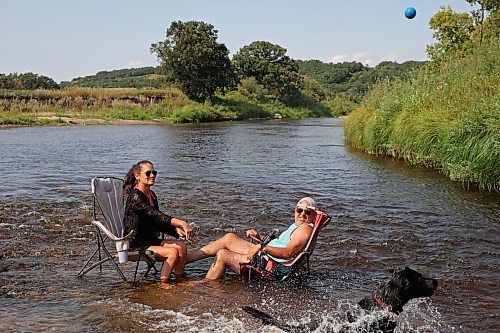 22082024
Victoria and Stephen Findlay cool their heels in the Little Saskatchewan River along with their dog Wesley on a hot Friday afternoon.  (Tim Smith/The Brandon Sun)