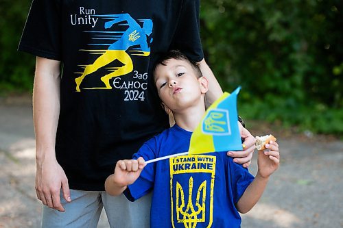 MIKAELA MACKENZIE / WINNIPEG FREE PRESS
	
Danylo Chychkevych (six) waves a Ukrainian flag on Friday, Aug. 23, 2024. A fundraising run for military supplies in Ukraine is being held on Saturday. Nazariy Chychkevych, a Ukrainian newcomer, is one of the organizers. 

For Matt story.
Winnipeg Free Press 2024