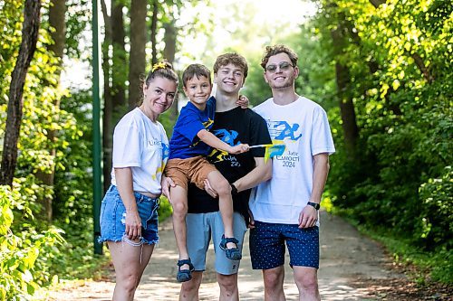 MIKAELA MACKENZIE / WINNIPEG FREE PRESS
	
Olesia (left), Danylo (six), Bohdan (17), and Nazariy Chychkevych on Friday, Aug. 23, 2024. A fundraising run for military supplies in Ukraine is being held on Saturday. Nazariy Chychkevych, a Ukrainian newcomer, is one of the organizers. 

For Matt story.
Winnipeg Free Press 2024