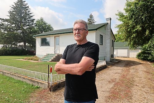 Ray Muirhead, mayor of the town of Carberry stands in front of a two-bedroom home that is across the street from the Carberry and District Health Centre. Town council recently purchased the home as a way to attract and retain a physician for the community. (Michele McDougall/The Brandon Sun)