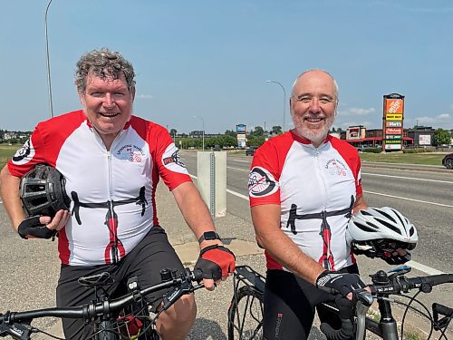 Mike Loghrin (left) and Jim Redmond stop for a breather in Brandon on Saturday as they raise funds and awareness for Parkinson's disease in the Spinning Wheels Relay. Their trek will take them from Victoria, B.C. to Ottawa, Ont. (Michele McDougall/The Brandon Sun)

