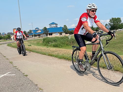 Jim Redmond leads the way with Mike Loghrin in behind. The two stopped in Brandon on Saturday as they raise funds and awareness for Parkinson's disease in the Spinning Wheels Relay. Their trek will take them from Victoria, B.C. to Ottawa, Ont. (Michele McDougall/The Brandon Sun)