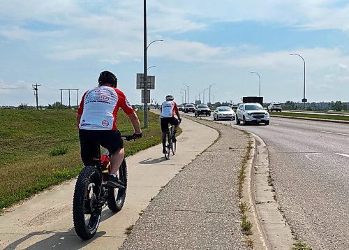 Cyclists Jim Redmond and Mike Loghrin on their Spinning Wheels Relay, a fundraiser for Parkinson's disease. The two stopped in Brandon as part of their trek that started in Victoria, B.C., and will end in Ottawa, Ont. (Michele McDougall/The Brandon Sun)