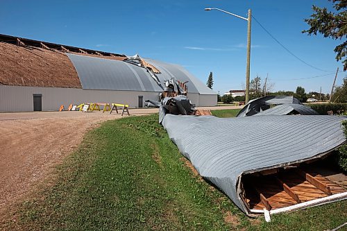 Sections of the Foxwarren Arena roof lie strewn along the street and on properties surrounding the facility on Monday after a storm caused heavy damage to the building early Sunday morning. (Tim Smith/The Brandon Sun)