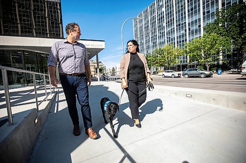 MIKAELA MACKENZIE / WINNIPEG FREE PRESS
	
Justice minister Matt Wiebe, victim services worker Carla Deeley, and victim services support dog Gloucester (aka Glossy) outside the law courts on Monday, Aug. 26, 2024. 

For Nicole story.
Winnipeg Free Press 2024