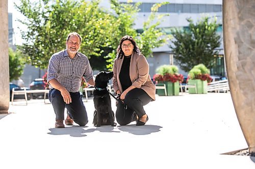 MIKAELA MACKENZIE / WINNIPEG FREE PRESS
	
Justice minister Matt Wiebe, victim services worker Carla Deeley, and victim services support dog Gloucester (aka Glossy) outside the law courts on Monday, Aug. 26, 2024. 

For Nicole story.
Winnipeg Free Press 2024