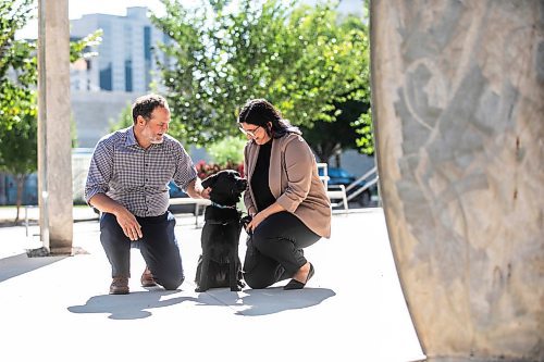 MIKAELA MACKENZIE / WINNIPEG FREE PRESS
	
Justice minister Matt Wiebe, victim services worker Carla Deeley, and victim services support dog Gloucester (aka Glossy) outside the law courts on Monday, Aug. 26, 2024. 

For Nicole story.
Winnipeg Free Press 2024