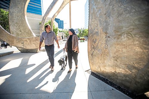 MIKAELA MACKENZIE / WINNIPEG FREE PRESS
	
Justice minister Matt Wiebe, victim services worker Carla Deeley, and victim services support dog Gloucester (aka Glossy) outside the law courts on Monday, Aug. 26, 2024. 

For Nicole story.
Winnipeg Free Press 2024