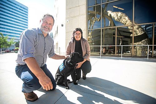 MIKAELA MACKENZIE / WINNIPEG FREE PRESS
	
Justice minister Matt Wiebe, victim services worker Carla Deeley, and victim services support dog Gloucester (aka Glossy) outside the law courts on Monday, Aug. 26, 2024. 

For Nicole story.
Winnipeg Free Press 2024