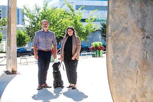 MIKAELA MACKENZIE / WINNIPEG FREE PRESS
	
Justice minister Matt Wiebe, victim services worker Carla Deeley, and victim services support dog Gloucester (aka Glossy) outside the law courts on Monday, Aug. 26, 2024. 

For Nicole story.
Winnipeg Free Press 2024