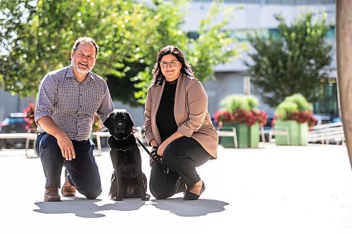 MIKAELA MACKENZIE / WINNIPEG FREE PRESS
	
Justice minister Matt Wiebe, victim services worker Carla Deeley, and victim services support dog Gloucester (aka Glossy) outside the law courts on Monday, Aug. 26, 2024. 

For Nicole story.
Winnipeg Free Press 2024