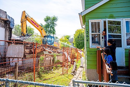 NIC ADAM / FREE PRESS
A crew demolishes the vacant house along Manitoba Ave. that burned down due to multiple fires in a few short months. According to the land-owner, the city approved his months-old demolition permit after the release of our last article on the subject.
240826 - Monday, August 26, 2024.

Reporter: Malak