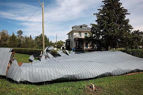 26082024
Portions of the Foxwarren District Rec. Centre roof lie strewn along the street and yards surrounding the recreation centre Monday after and early morning storm on Sunday ripped a large portion of the roof off of the building. 
(Tim Smith/The Brandon Sun)