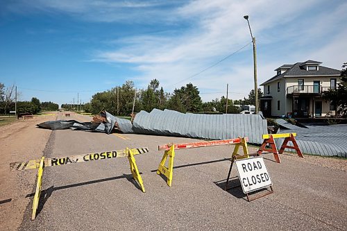 26082024
Portions of the Foxwarren District Rec. Centre roof lie strewn along the street and yards surrounding the recreation centre Monday after and early morning storm on Sunday ripped a large portion of the roof off of the building. 
(Tim Smith/The Brandon Sun)