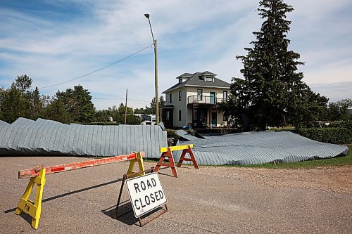 26082024
Portions of the Foxwarren District Rec. Centre roof lie strewn along the street and yards surrounding the recreation centre Monday after and early morning storm on Sunday ripped a large portion of the roof off of the building. 
(Tim Smith/The Brandon Sun)