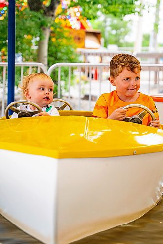 NIC ADAM / FREE PRESS
Brothers Bodhi, 1, and Ozzy Shaw, 6, take a boat ride at Tinker Town Monday afternoon.
240826 - Monday, August 26, 2024.

Reporter: ?