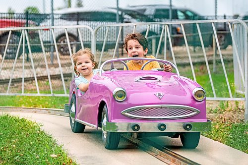 NIC ADAM / FREE PRESS
Louise (left), 2, and Freddie Neville, 5, have fun on the miniature cars at Tinker Town Monday.
240826 - Monday, August 26, 2024.

Reporter: ?