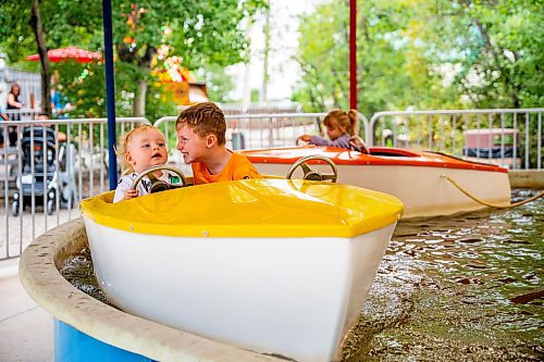 NIC ADAM / FREE PRESS
Brothers Bodhi, 1, and Ozzy Shaw, 6, take a boat ride at Tinker Town Monday afternoon.
240826 - Monday, August 26, 2024.

Reporter: ?