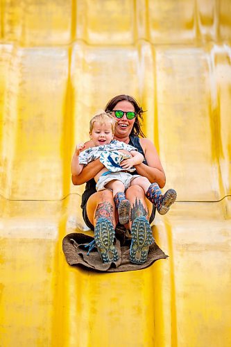 NIC ADAM / FREE PRESS
Two-and-a-half year old Caleb Campbell, and his mom Melissa, have fun on the Super Slide  at Tinker Town Monday afternoon.
240826 - Monday, August 26, 2024.

Reporter: ?