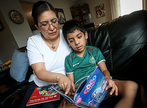 JOHN WOODS / FREE PRESS
Aline Tezcucano, who immigrated from Mexico in 2003, and her seven year old son Riley read spanish books in their home Monday, August 26, 2024. Tezcucano is teaching her son spanish.

Reporter: ?