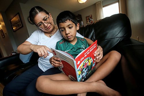 JOHN WOODS / FREE PRESS
Aline Tezcucano, who immigrated from Mexico in 2003, and her seven year old son Riley read spanish books in their home Monday, August 26, 2024. Tezcucano is teaching her son spanish.

Reporter: ?