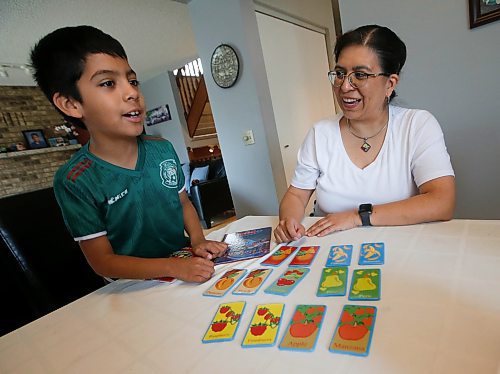 JOHN WOODS / FREE PRESS
Aline Tezcucano, who immigrated from Mexico in 2003, and her seven year old son Riley play a spanish word game in their home Monday, August 26, 2024. Tezcucano is teaching her son spanish.

Reporter: ?