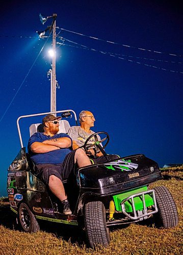 NIC ADAM / FREE PRESS
Phil Taylor (left) and Arnie Todosey watch the races from their modified golf cart at Thursday night thunder at Victory Lanes Speedway. 
240822 - Thursday, August 22, 2024.

Reporter: ?